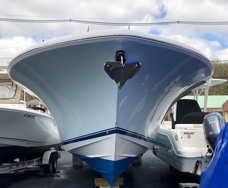 Slide: The Image of 2017 Buddy Davis 34 Center Console boat, front view, docked between other vessels. - 7