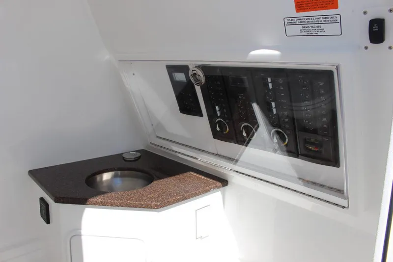 Slide: The Image of 2017 Buddy Davis 34 Center Console interior with control panel and sink. - 9