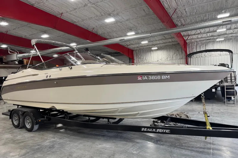 The Image of 1998 Regal 2800 LSR boat on trailer in indoor storage facility. - 1
