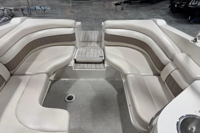 Slide: The Image of Interior of 1998 Regal 2800 LSR boat with beige seating and carpeted floor. - 11