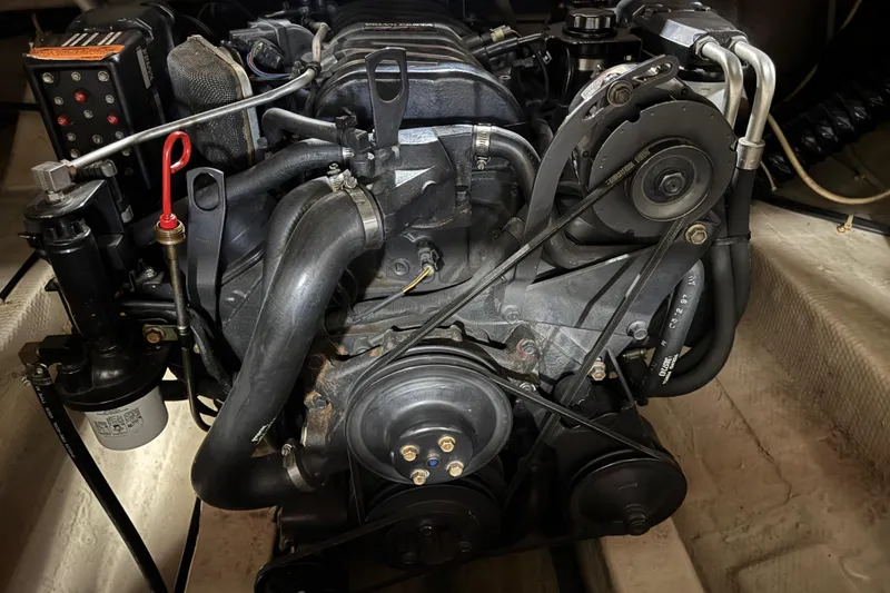 Slide: The Image of Engine of a 1998 Regal 2800 LSR boat, showcasing belts and components. - 12