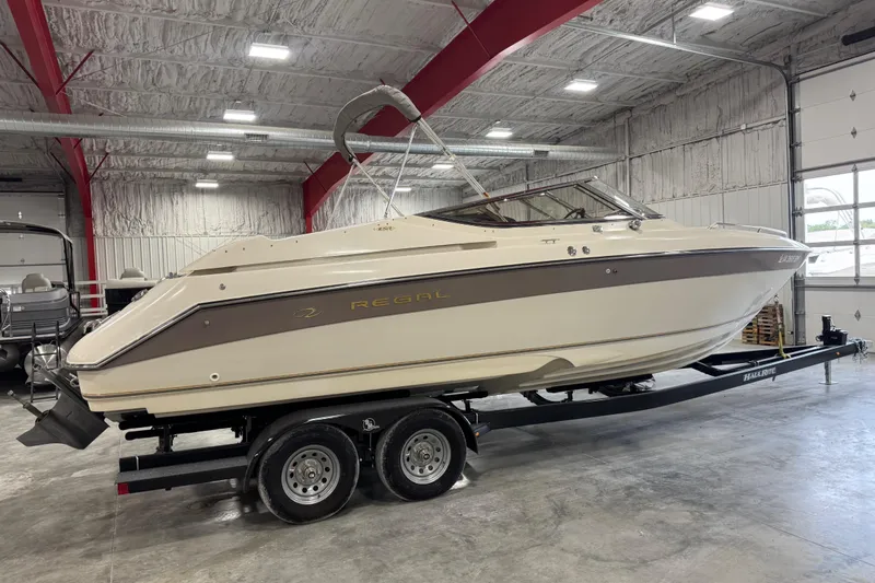 Slide: The Image of 1998 Regal 2800 LSR boat on trailer in indoor storage facility. - 2