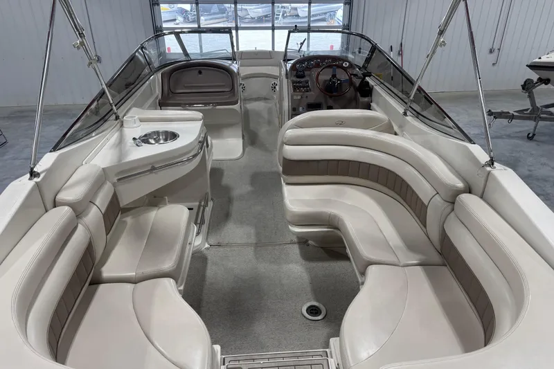 Slide: The Image of 1998 Regal 2800 LSR boat interior with plush seating and sleek design. - 4