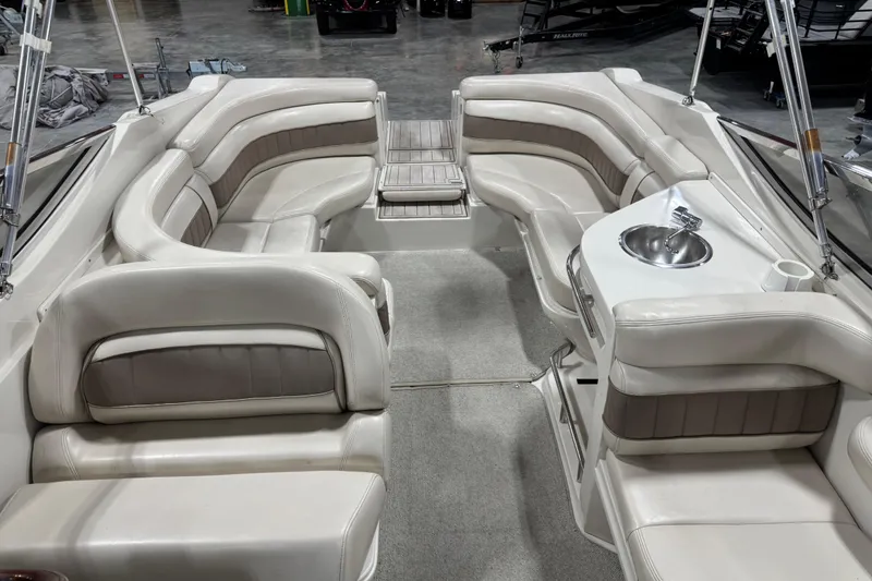 Slide: The Image of 1998 Regal 2800 LSR boat interior with plush seating and built-in sink. - 5