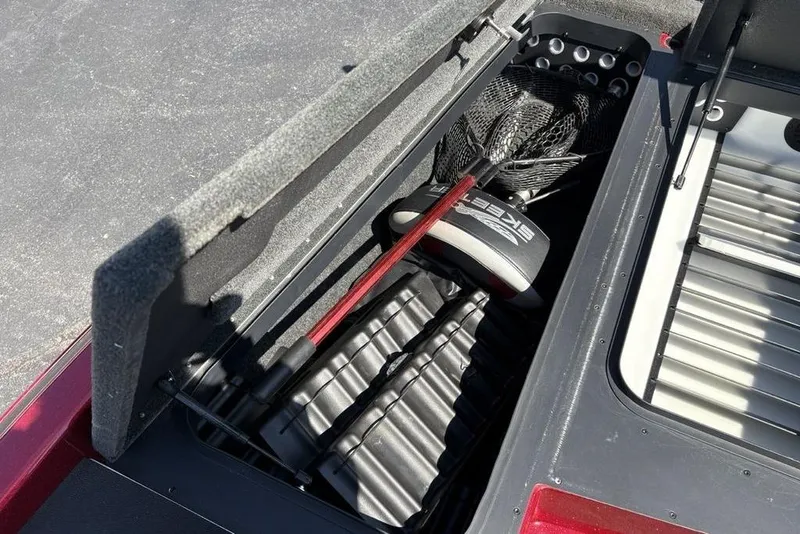 Slide: The Image of 2015 Skeeter ZX225 storage compartment with fishing gear and net. - 11