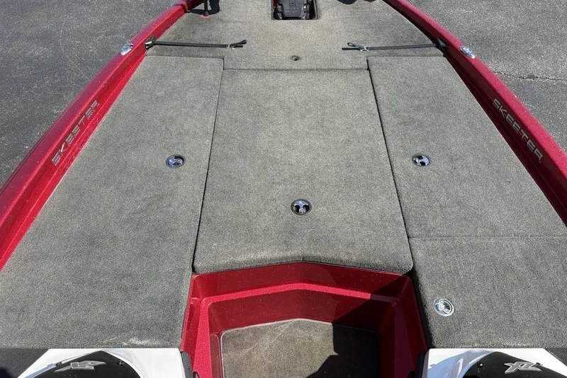 Slide: The Image of 2015 Skeeter ZX225 boat deck with red trim and carpeted surface. - 12