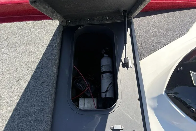 Slide: The Image of Open storage compartment in 2015 Skeeter ZX225 boat, showing interior equipment. - 16