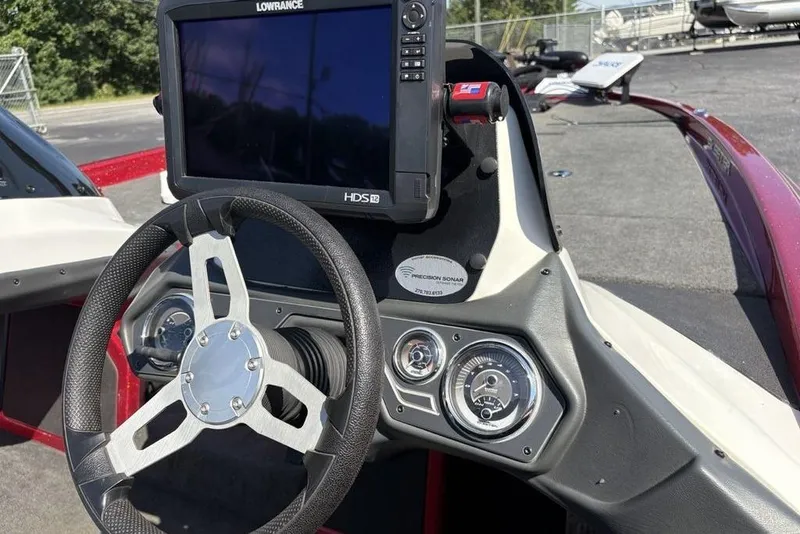 Slide: The Image of 2015 Skeeter ZX225 boat dashboard with steering wheel and Lowrance HDS-12 display. - 19