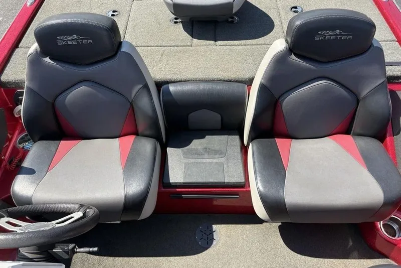 Slide: The Image of 2015 Skeeter ZX225 boat seats with red and gray upholstery, featuring Skeeter logo. - 21