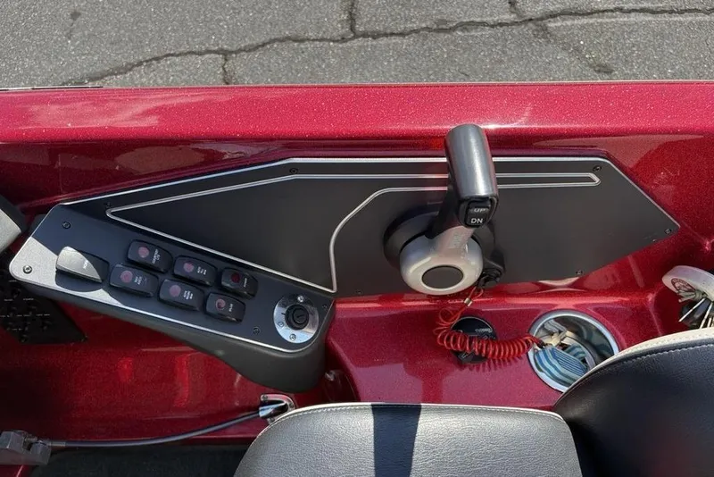 Slide: The Image of Control panel of a 2015 Skeeter ZX225 boat with switches and throttle lever. - 23