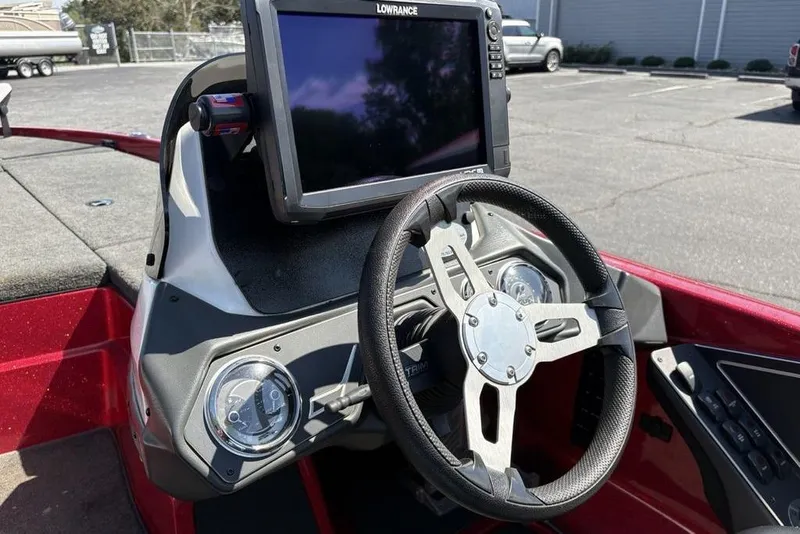 Slide: The Image of 2015 Skeeter ZX225 boat dashboard with steering wheel and Lowrance display. - 24