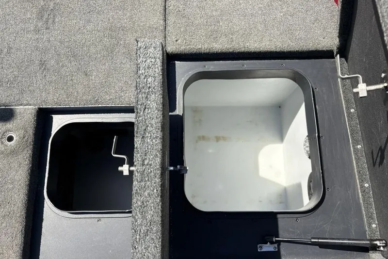 Slide: The Image of 2015 Skeeter ZX225 boat storage compartments with open lids, showing interior details. - 26