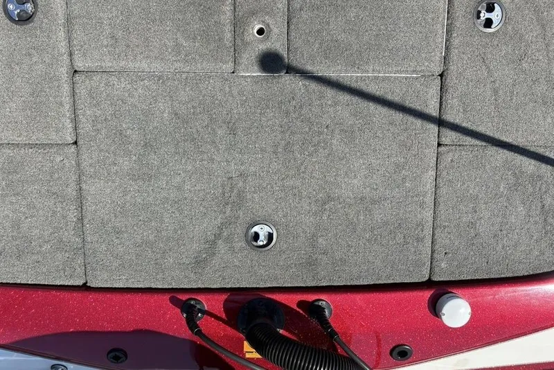 Slide: The Image of 2015 Skeeter ZX225 boat deck with gray carpet and red accents. - 27