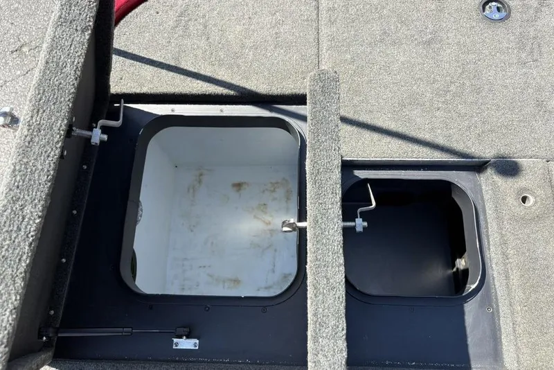 Slide: The Image of 2015 Skeeter ZX225 boat storage compartments with open lids, showing interior space. - 29