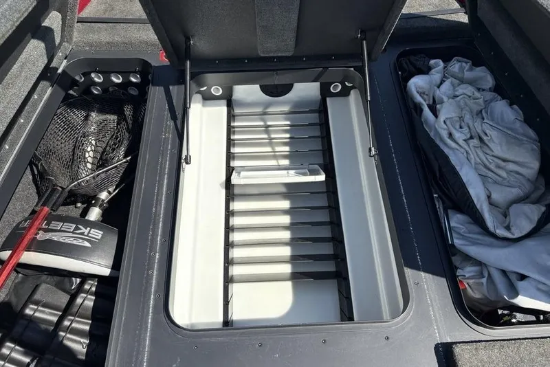 Slide: The Image of 2015 Skeeter ZX225 boat storage compartments with fishing gear and equipment. - 8