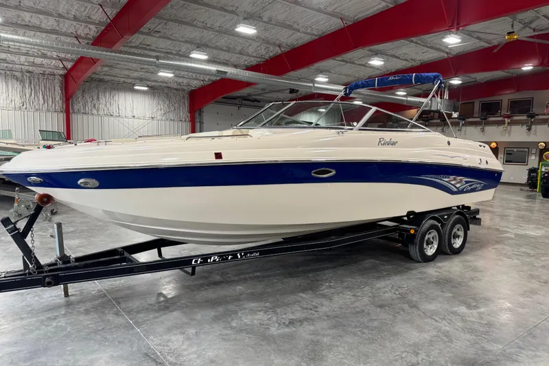 The Image of 2004 Rinker 282 Captiva Bowrider on trailer in indoor storage facility. - 1