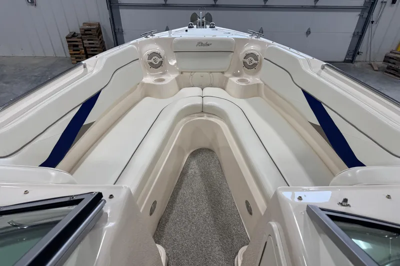 Slide: The Image of 2004 Rinker 282 Captiva Bowrider interior with white seating and blue accents. - 10