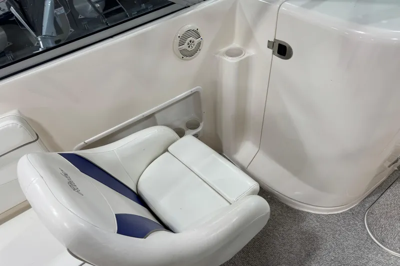 Slide: The Image of 2004 Rinker 282 Captiva Bowrider interior with white and blue seating. - 12