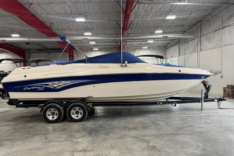 Slide: The Image of 2004 Rinker 282 Captiva Bowrider boat on trailer in indoor storage facility. - 13