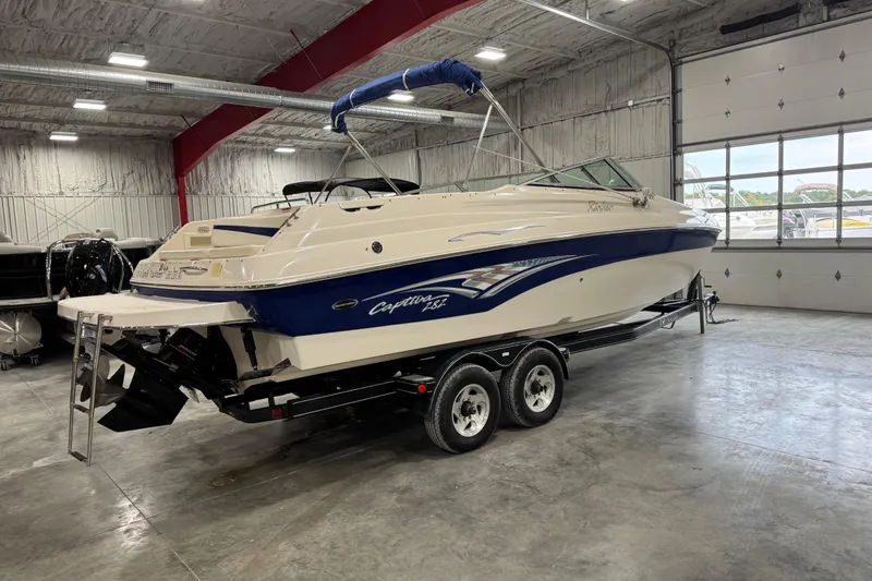 Slide: The Image of 2004 Rinker 282 Captiva Bowrider boat on trailer in indoor storage facility. - 4