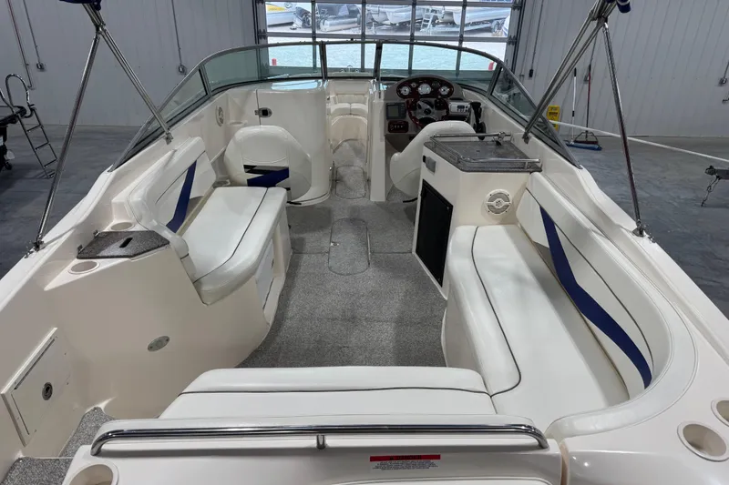 Slide: The Image of 2004 Rinker 282 Captiva Bowrider interior with white seating and modern dashboard. - 6