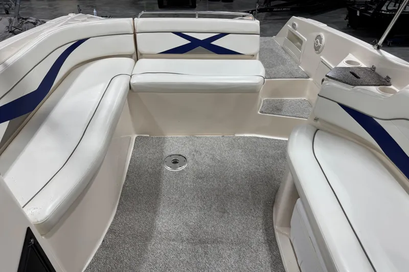 Slide: The Image of 2004 Rinker 282 Captiva Bowrider interior with white seating and blue accents. - 8