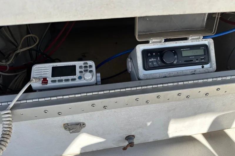 Slide: The Image of 1994 Bayliner 3888 Motoryacht radio and communication equipment in storage compartment. - 10