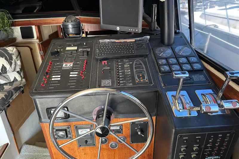 Slide: The Image of Control panel of a 1994 Bayliner 3888 Motoryacht with steering wheel and navigation instruments. - 11