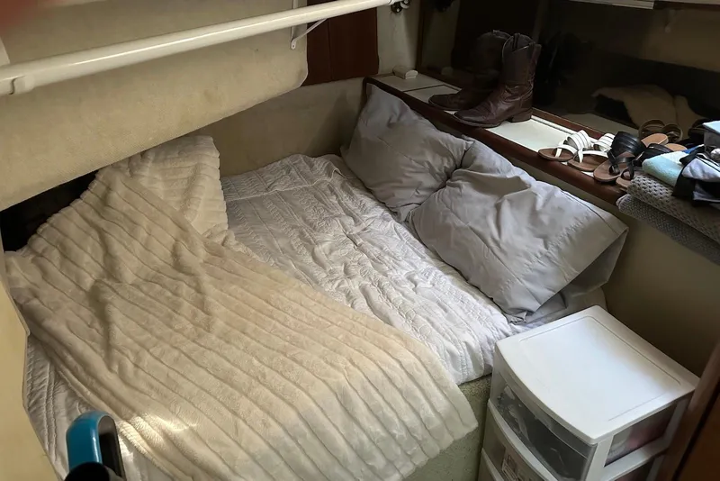 Slide: The Image of Cozy cabin interior of 1994 Bayliner 3888 Motoryacht with bed and storage. - 15