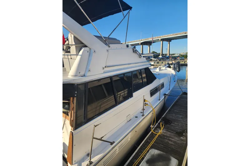 Slide: The Image of 1994 Bayliner 3888 Motoryacht docked at marina under blue sky. - 2
