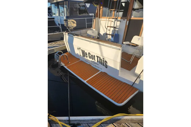 Slide: The Image of 1994 Bayliner 3888 Motoryacht deck with seating, grill, and storage at marina. - 5