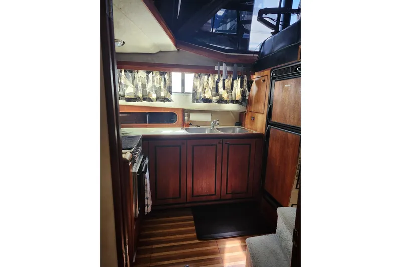 Slide: The Image of 1994 Bayliner 3888 Motoryacht cockpit with steering wheel, seating, and Garmin navigation system. - 8