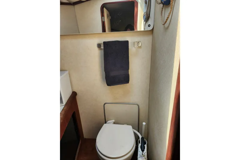 Slide: The Image of 1994 Bayliner 3888 Motoryacht helm with plush seating and steering wheel, docked at marina. - 9