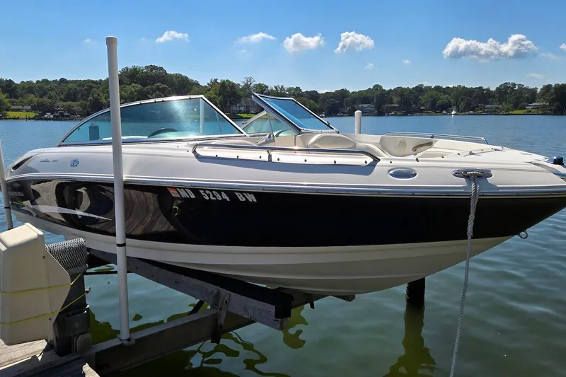 The Image of 2003 Monterey 228SI Montura Bowrider on a lift by a scenic lake. - 1