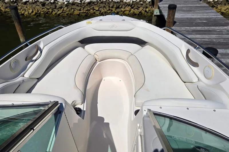 Slide: The Image of 2003 Monterey 228SI Montura Bowrider boat interior with white seating and open deck. - 12