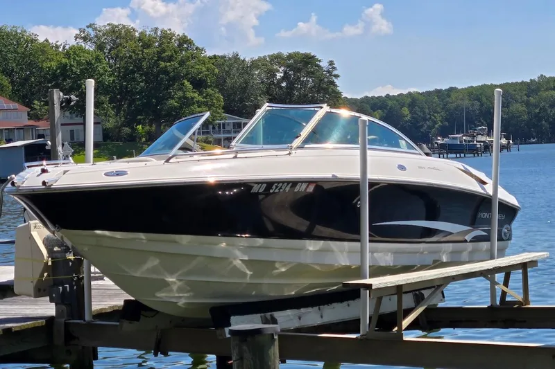 Slide: The Image of 2003 Monterey 228SI Montura Bowrider on a lift by a scenic lake. - 5