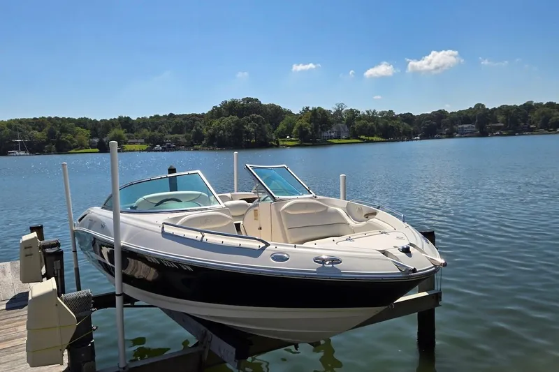 Slide: The Image of 2003 Monterey 228SI Montura Bowrider on a lake dock under clear blue skies. - 7