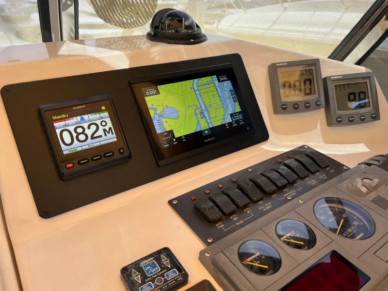 Slide: The Image of Control panel of 2001 Legacy Yachts 28 Express with navigation and monitoring displays. - 18