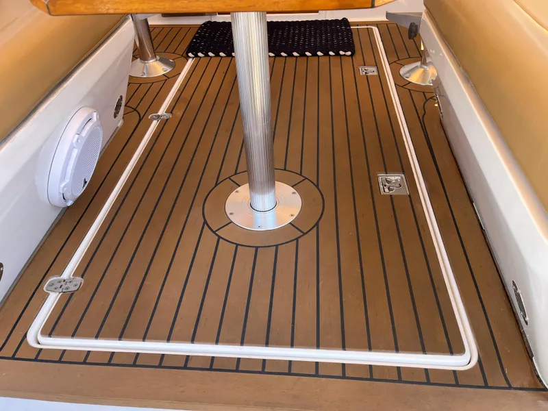 Slide: The Image of 2001 Legacy Yachts 28 Express interior with teak flooring and seating area. - 25