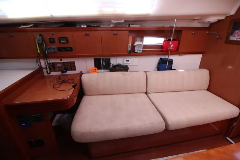 Slide: The Image of Interior of 2016 Beneteau Oceanis 40 sailboat with beige seating and wooden cabinetry. - 10