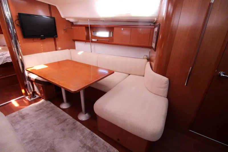 Slide: The Image of Interior of 2016 Beneteau Oceanis 40 yacht with cozy seating and wooden table. - 12