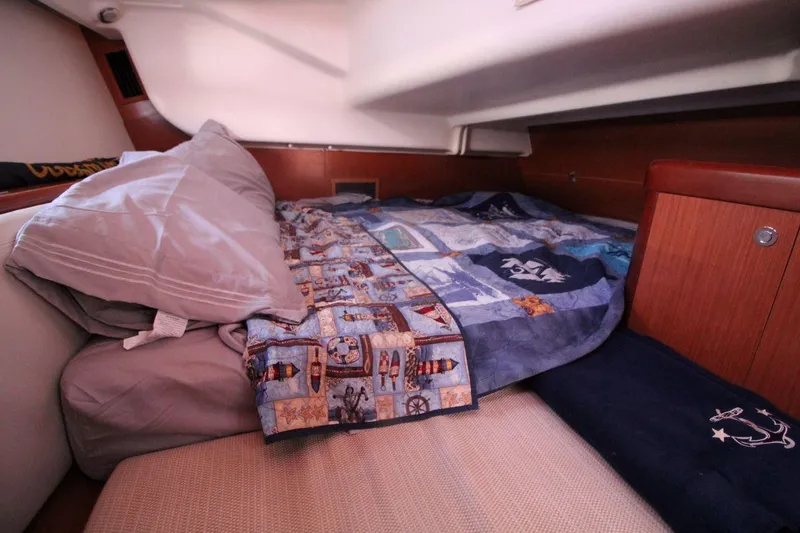 Slide: The Image of Cozy cabin interior of 2016 Beneteau Oceanis 40 with colorful quilt and pillows. - 15