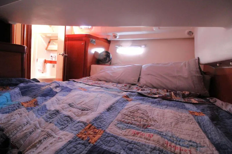 Slide: The Image of Cozy cabin interior of 2016 Beneteau Oceanis 40 sailboat with quilted bedding. - 17