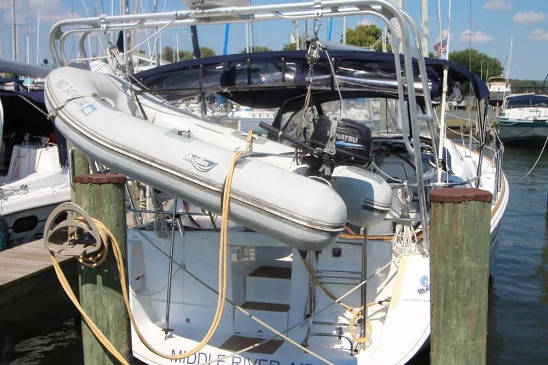 Slide: The Image of 2016 Beneteau Oceanis 40 sailboat docked with dinghy and outboard motor. - 2
