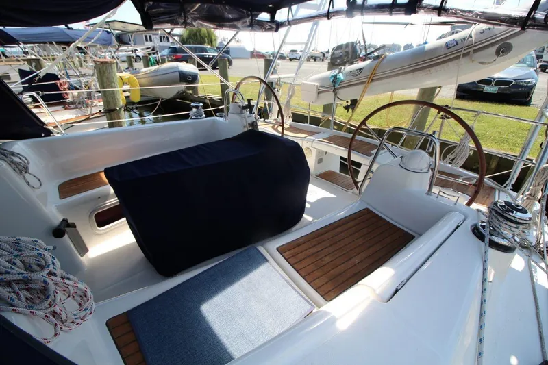 Slide: The Image of 2016 Beneteau Oceanis 40 sailboat cockpit with dual steering wheels and wooden deck. - 3