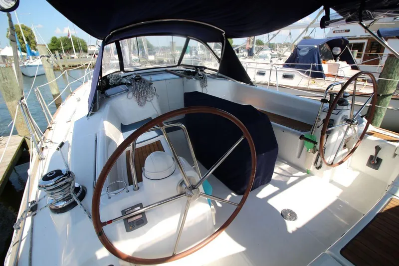 Slide: The Image of Cockpit of 2016 Beneteau Oceanis 40 sailboat with dual steering wheels and marina view. - 4