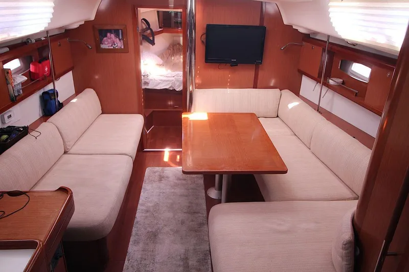 Slide: The Image of Interior of 2016 Beneteau Oceanis 40 yacht with cozy seating and wooden table. - 9