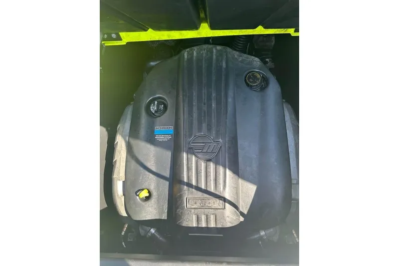 Slide: The Image of 2023 Axis A225 engine compartment with Monsoon cover, showcasing mechanical components. - 10