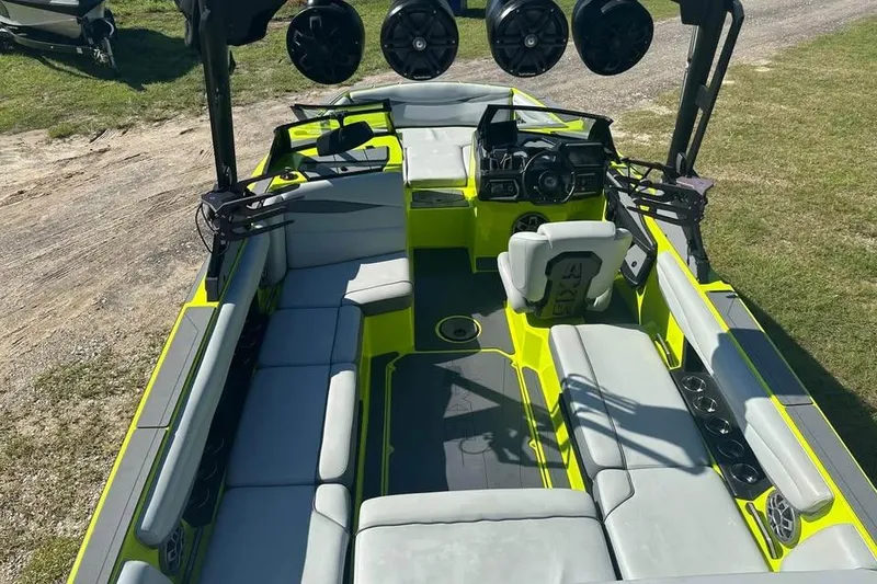 Slide: The Image of 2023 Axis A225 boat interior with vibrant seating and advanced audio system. - 11