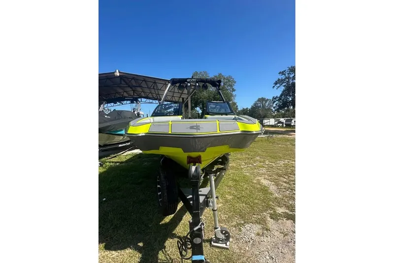 Slide: The Image of 2023 Axis A225 boat on trailer under clear blue sky. - 13